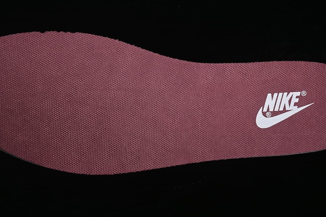 Burgundy textured insole with a Nike logo