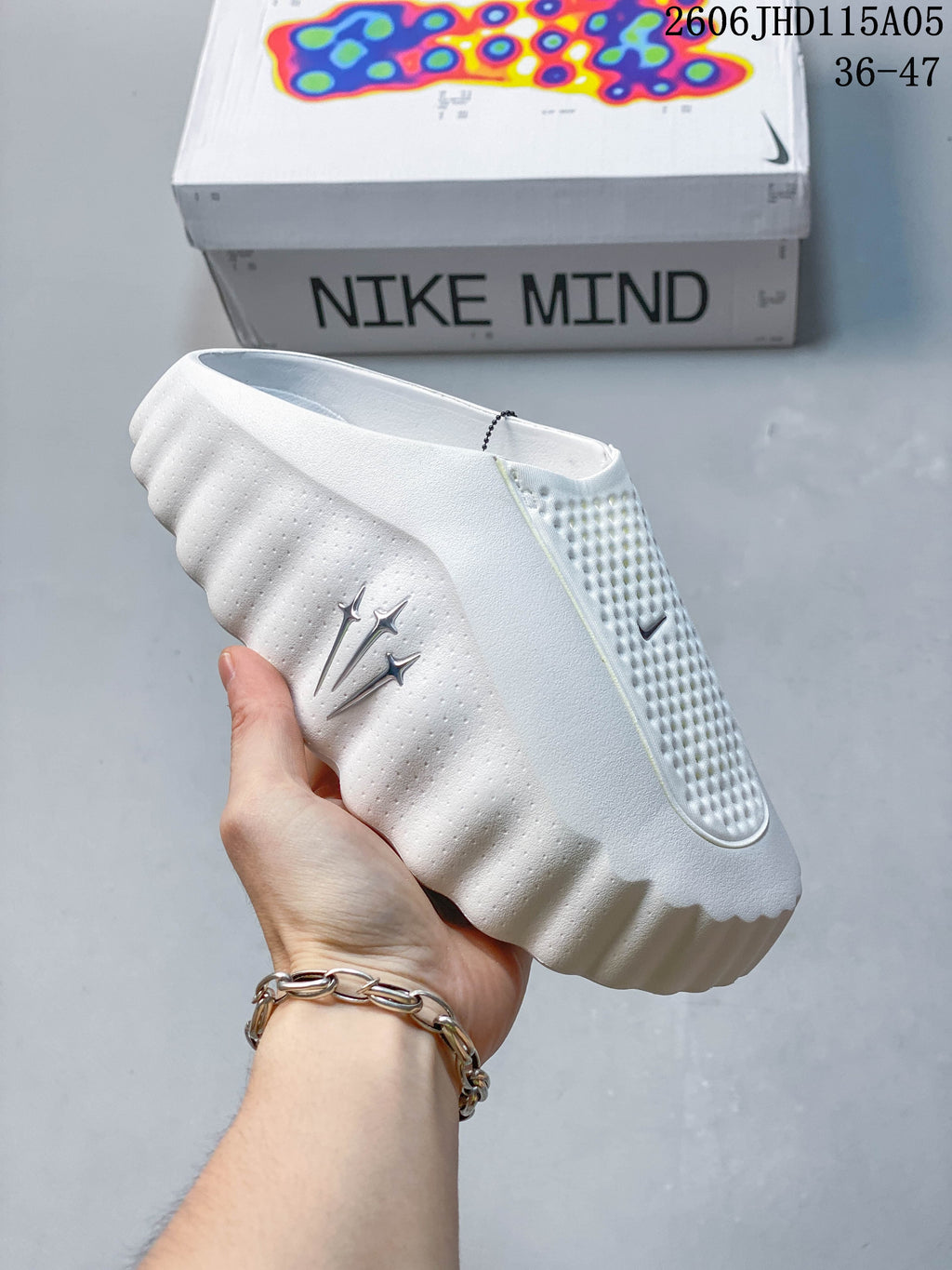 White Nike Mind slide shown from the side