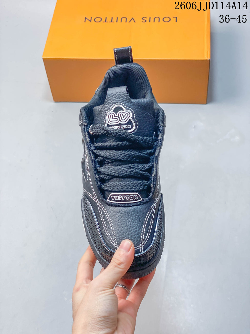 Top view of the sneaker showing its laces, tongue and stitched panels
