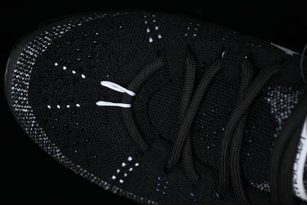 Close-up of the toe, knit pattern and lace-up front