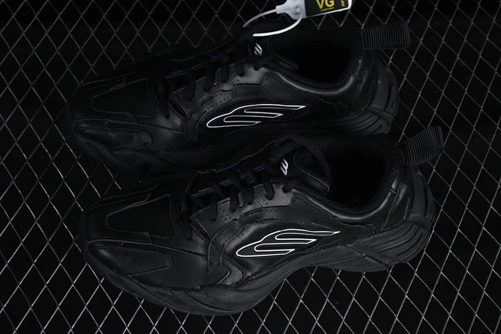 Pair of black low-top sneakers shown from above