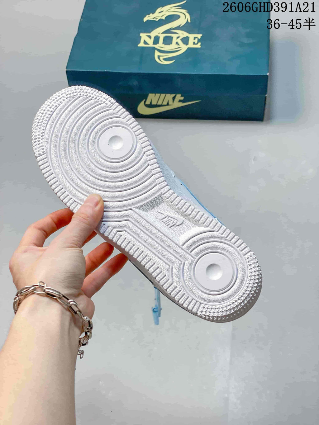 Underside of the white Nike Air Force 1 sneaker showing the patterned rubber outsole.