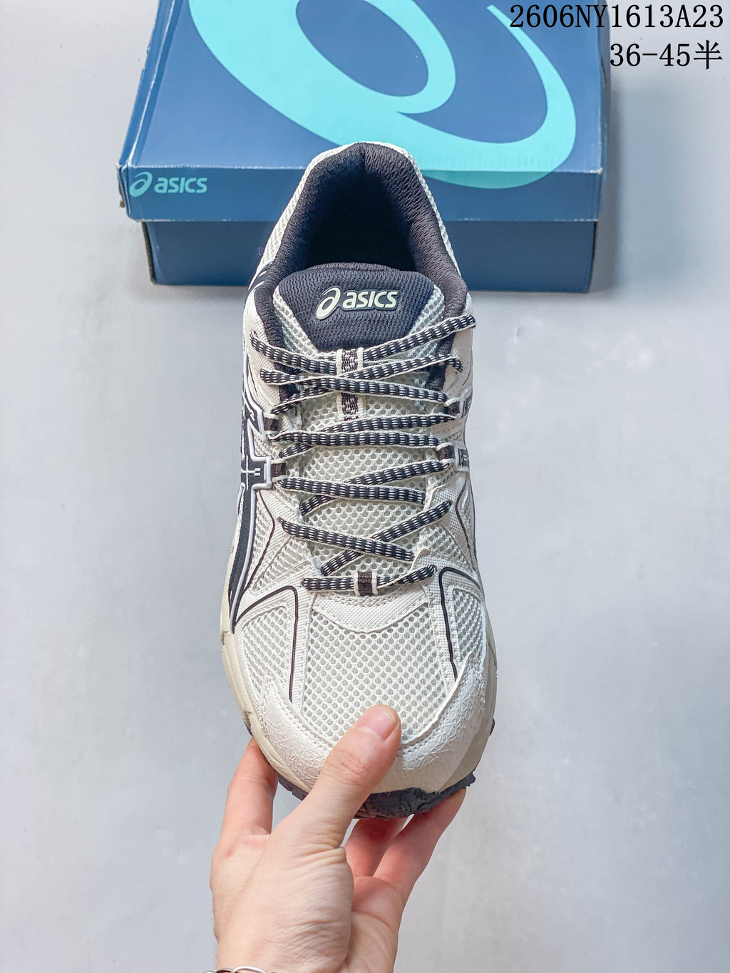 Top view of the laces and tongue on a cream and navy ASICS Gel-Kahana 8 shoe