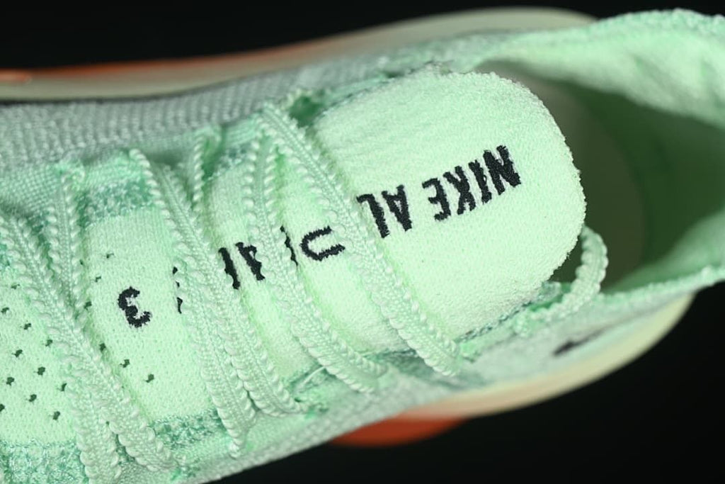 Close-up of the tongue and mint-green laces.