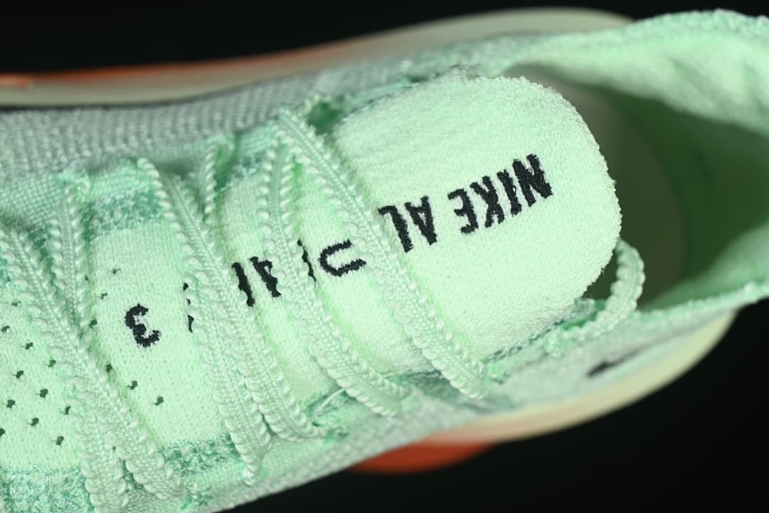 Close-up of the tongue and mint-green laces.