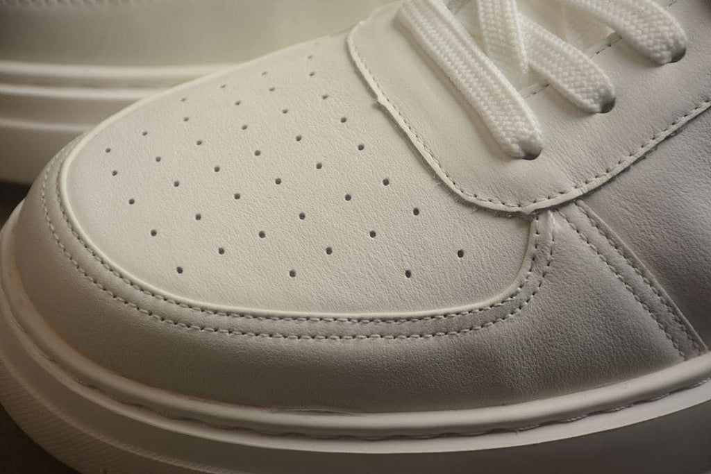 Close-up of perforations on the toe panel and stitched overlays