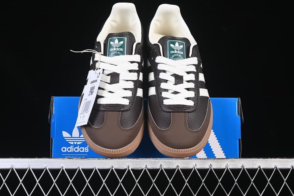 Front view of the sneakers displayed on a blue adidas box