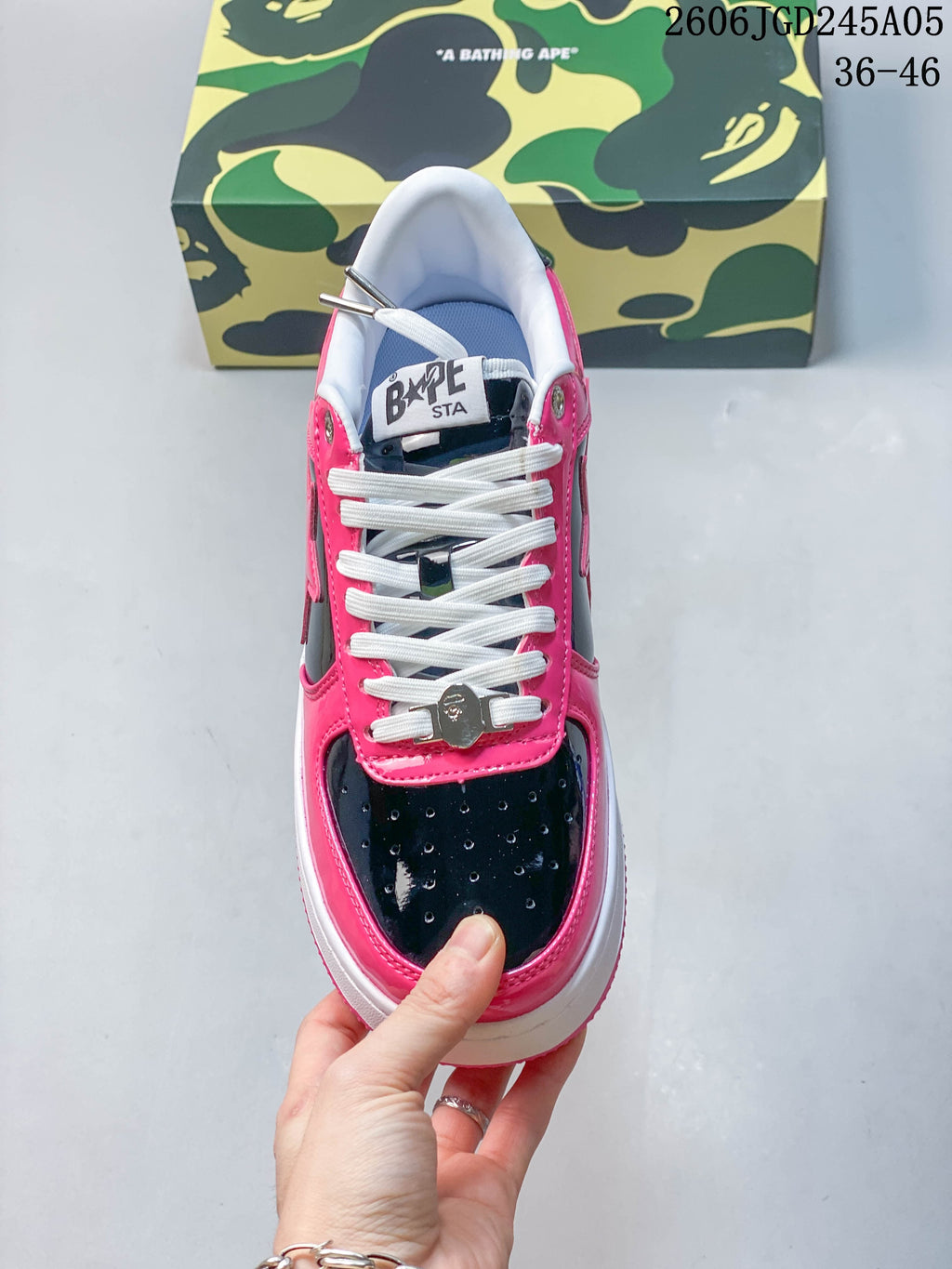 Top view of the sneaker showing white laces and perforated black toe panels