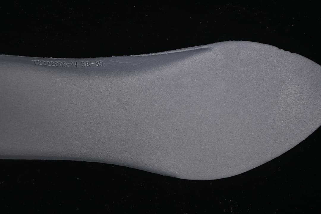 Close-up of the shoe insole showing a printed code and size marking