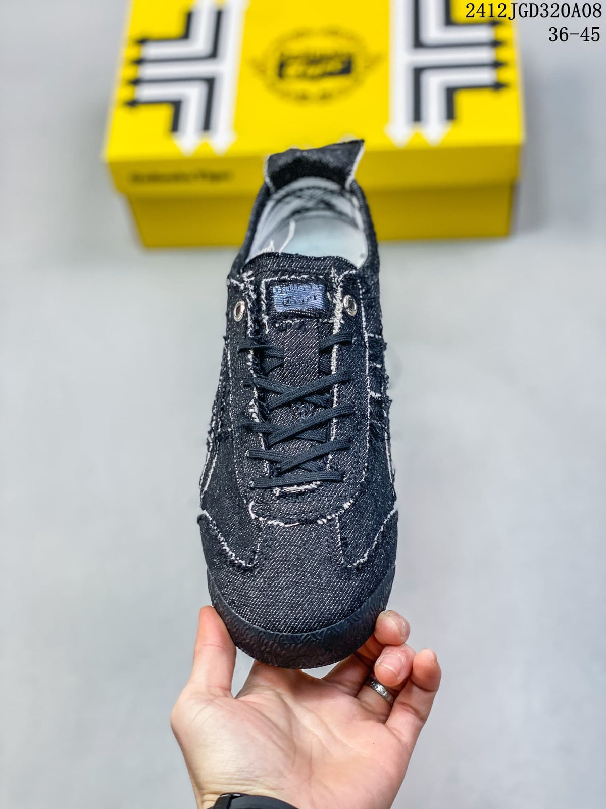 Front view showing the laces, metal eyelets and stitched panels