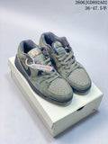 Pair of sage-green and navy Jordan Stadium 90 sneakers displayed on a shoebox.