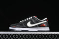 Side view of a black low-top sneaker with white laces, a white Swoosh, red accents, and a white midsole.