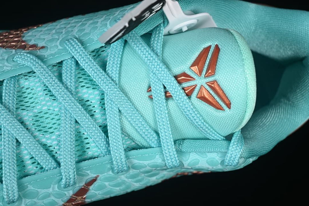 Close-up of the tongue emblem, laces and patterned upper.
