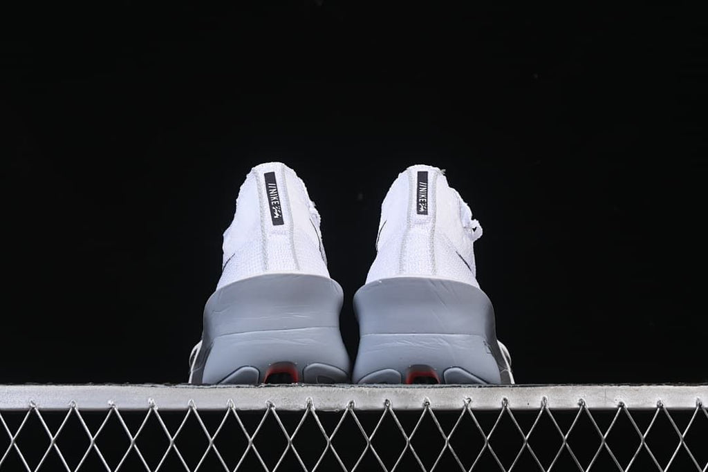 Rear view of both shoes showing their sculpted heels and soles