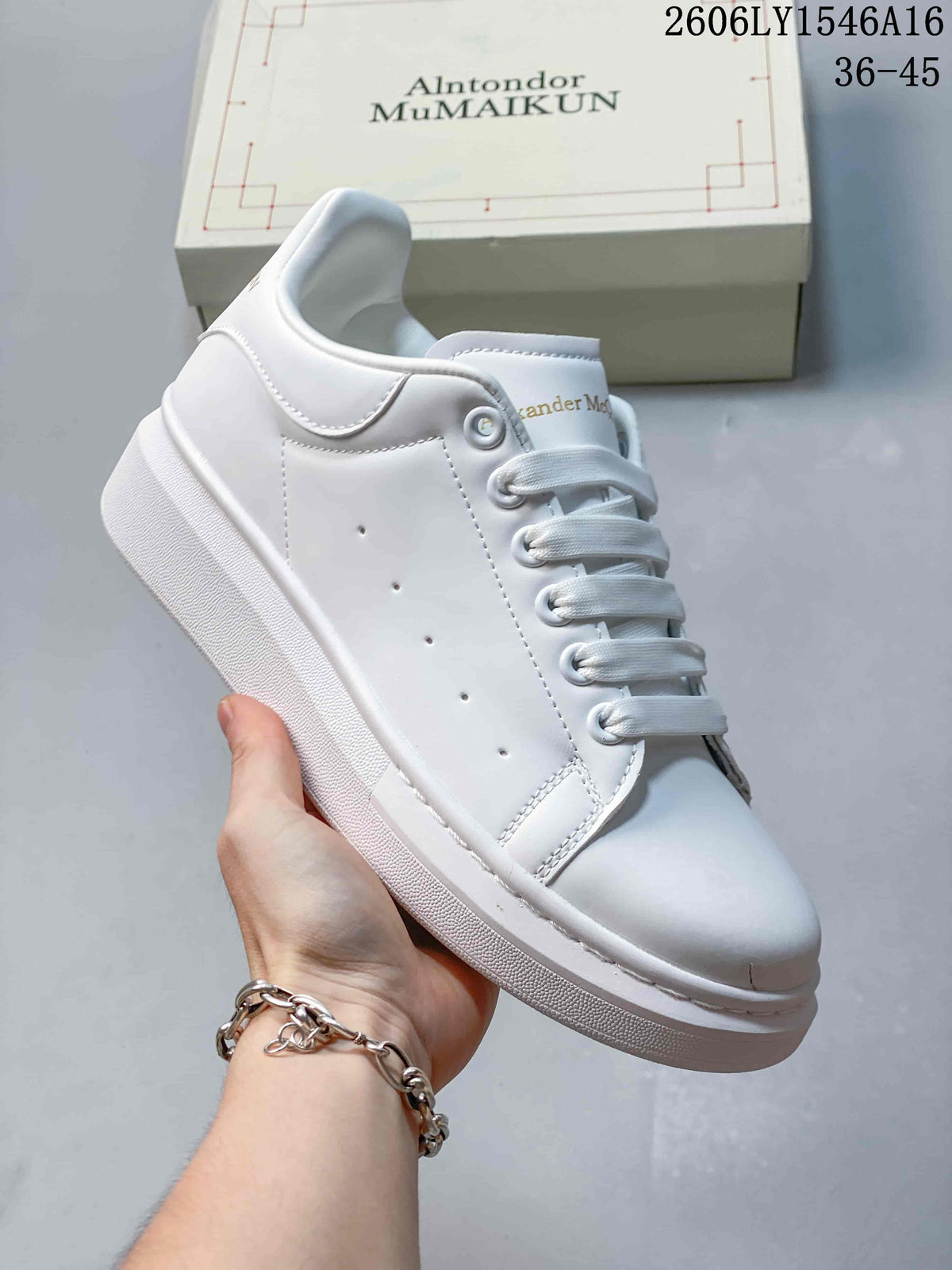 Angled side view of a white low-top sneaker with perforated panels and a chunky sole.