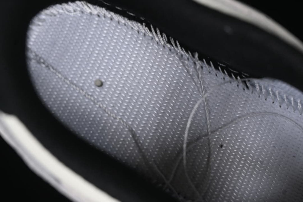 Close-up of the sneaker's grey perforated interior lining