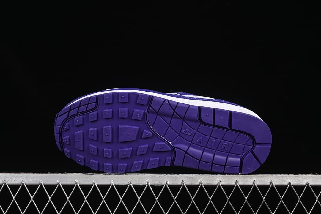 Underside view showing the purple outsole tread