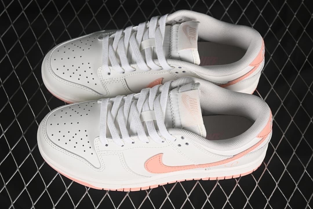 Pair of off-white and pink low-top sneakers viewed from above