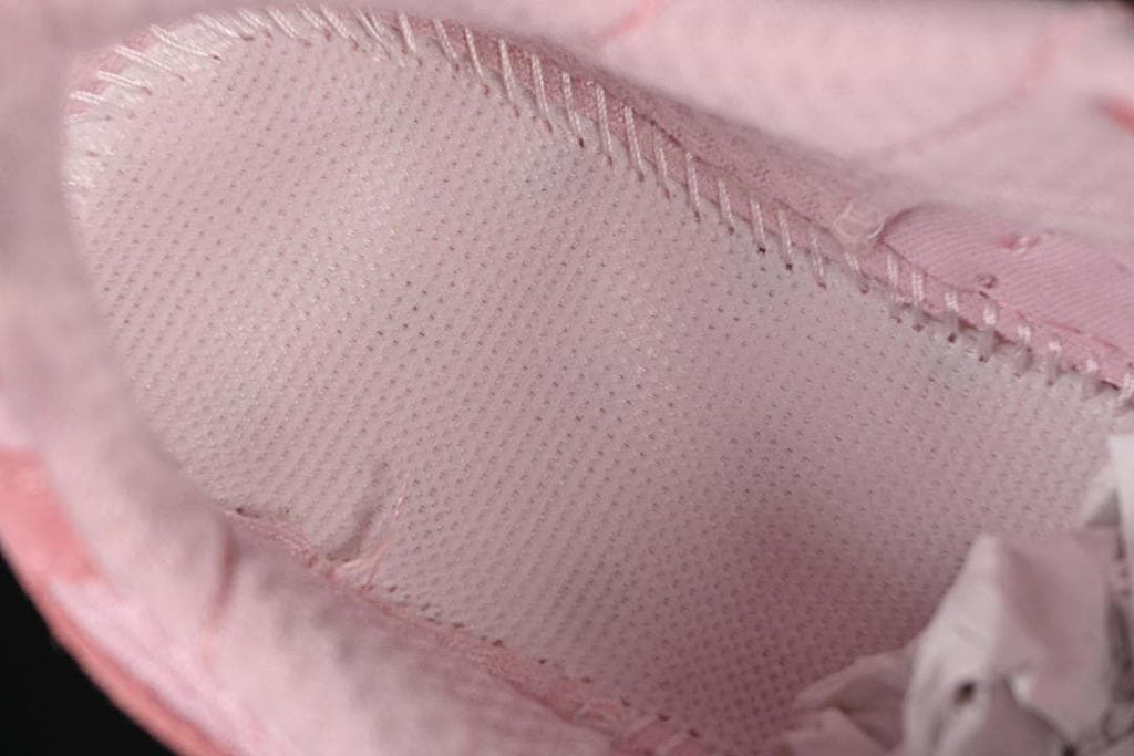 Close-up of the pink shoe's interior lining and stitching.