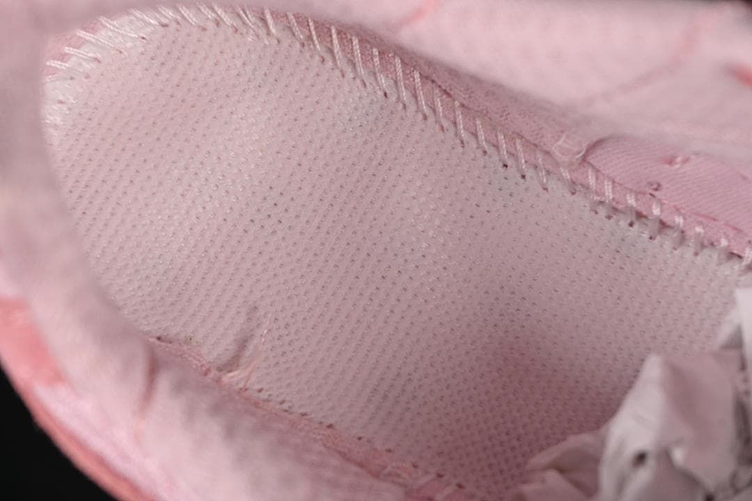 Close-up of the pink shoe's interior lining and stitching.