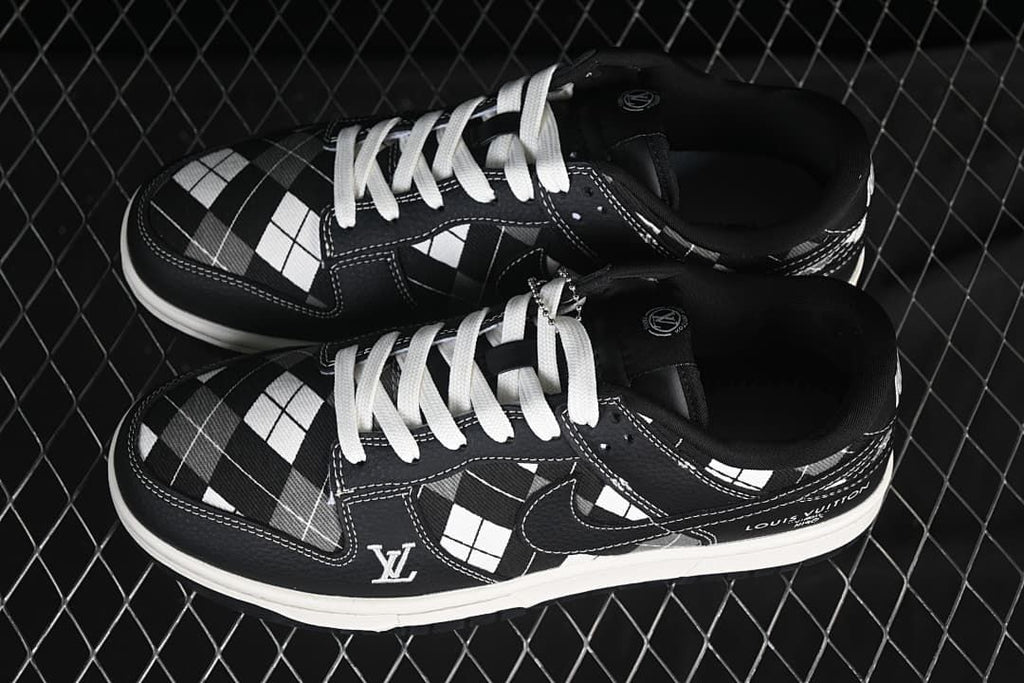Pair of black-and-white grid-pattern low-top sneakers with white laces, shown from above.