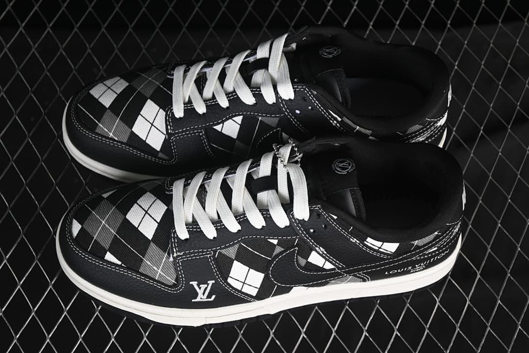 Pair of black-and-white grid-pattern low-top sneakers with white laces, shown from above.