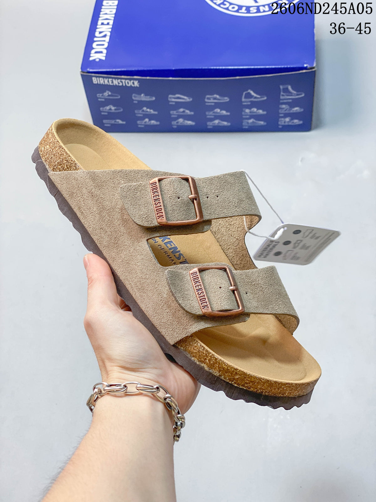 Taupe two-strap sandal with adjustable buckles and a textured sole.
