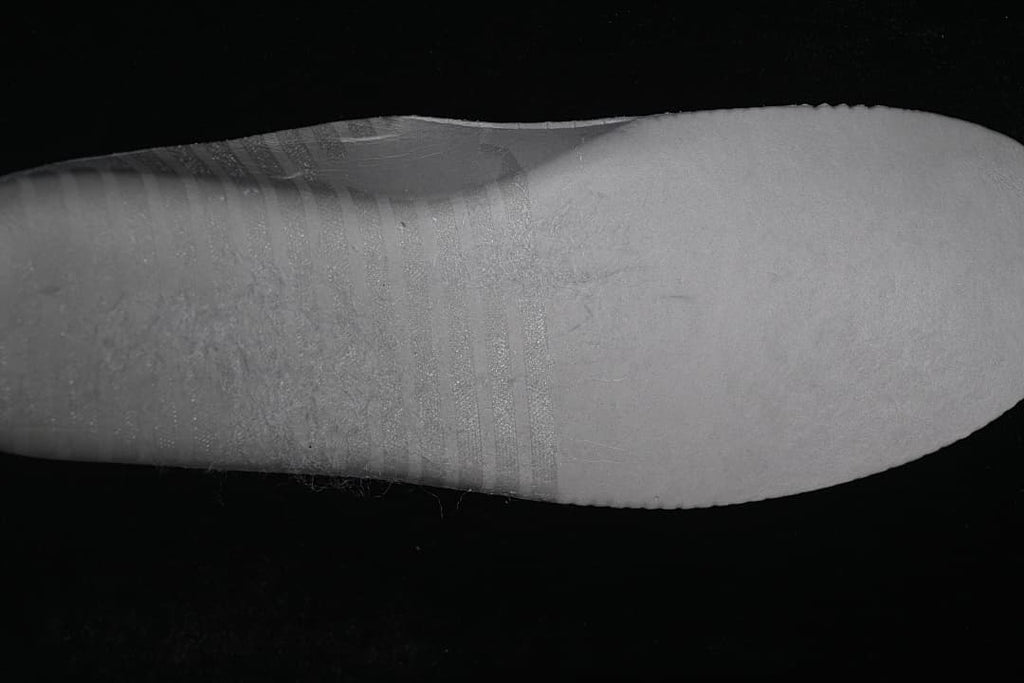 Close-up view of the sneaker's white sole and sidewall.