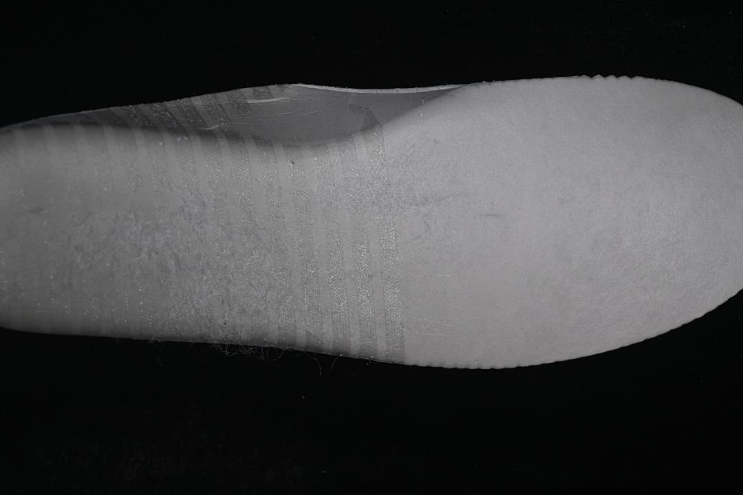 Close-up view of the sneaker's white sole and sidewall.