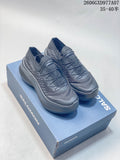 Pair of gray Salomon low-top sneakers on a blue box, viewed from above and the side.