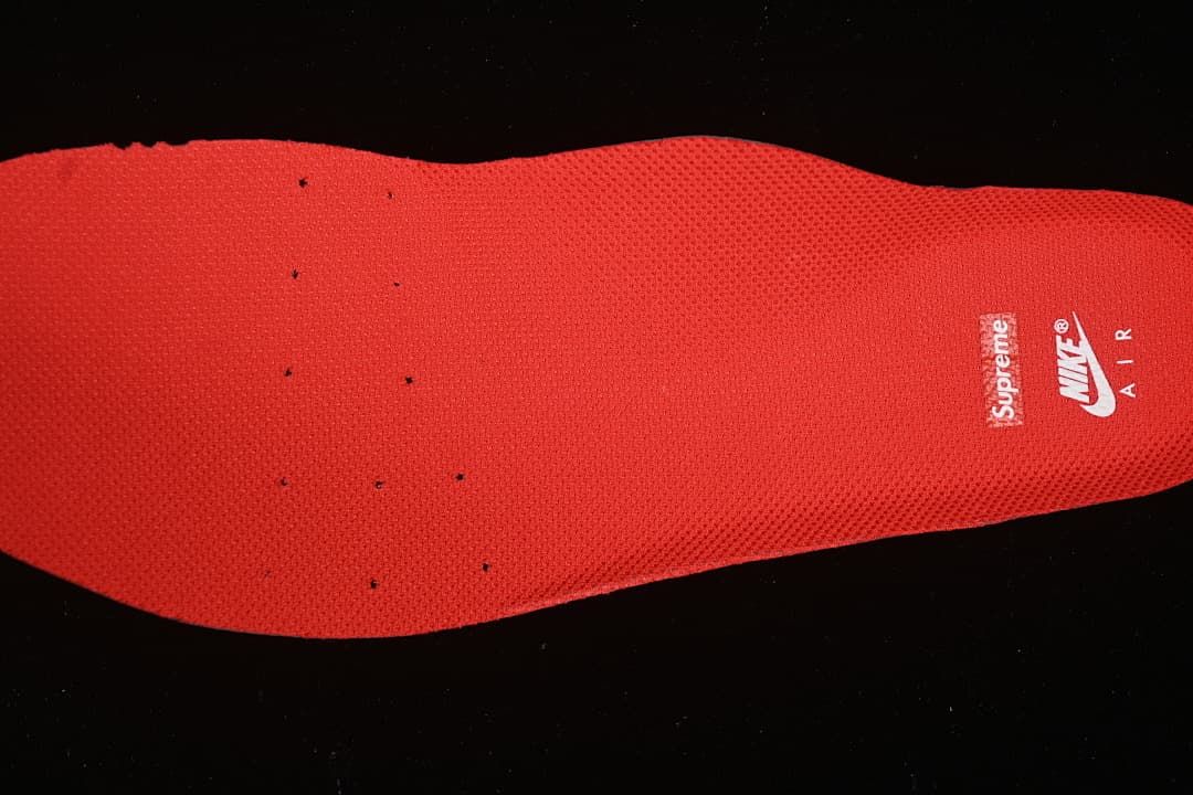 Red insole with Nike Air and Supreme branding