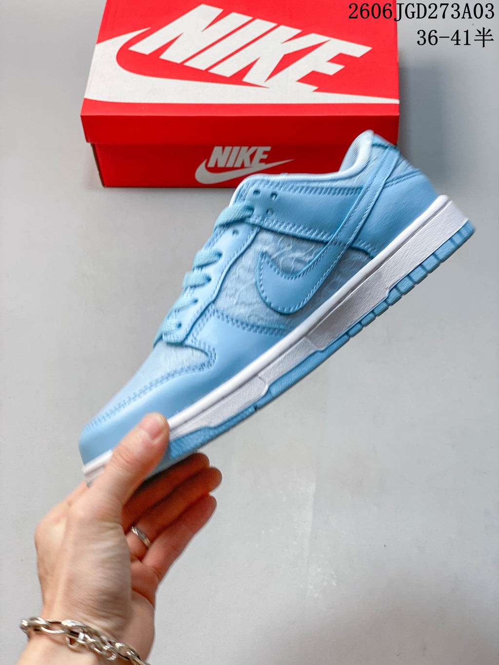 Side view of a light blue low-top sneaker with patterned side panels