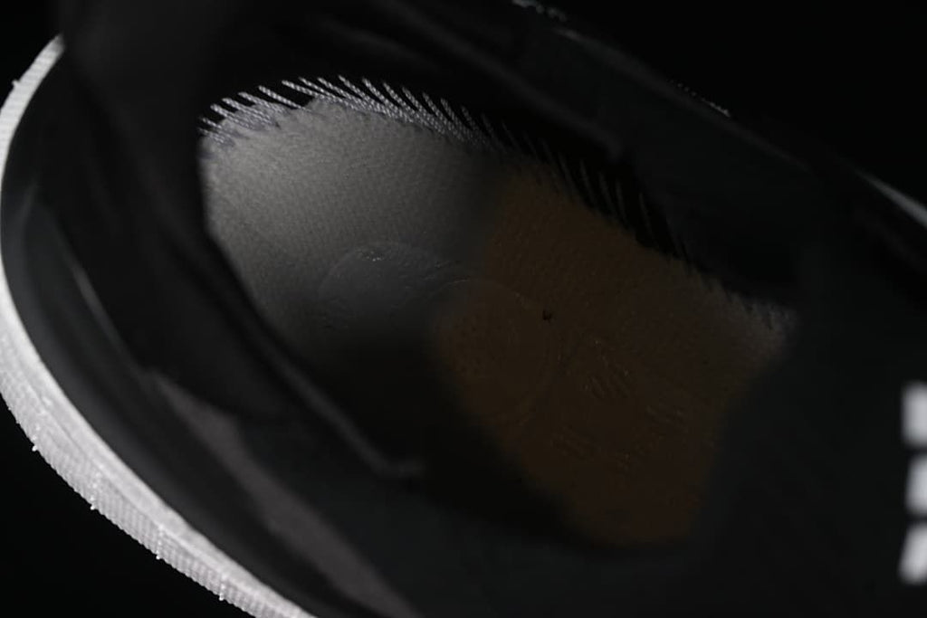 Interior view of the shoe showing the dark lining and footbed