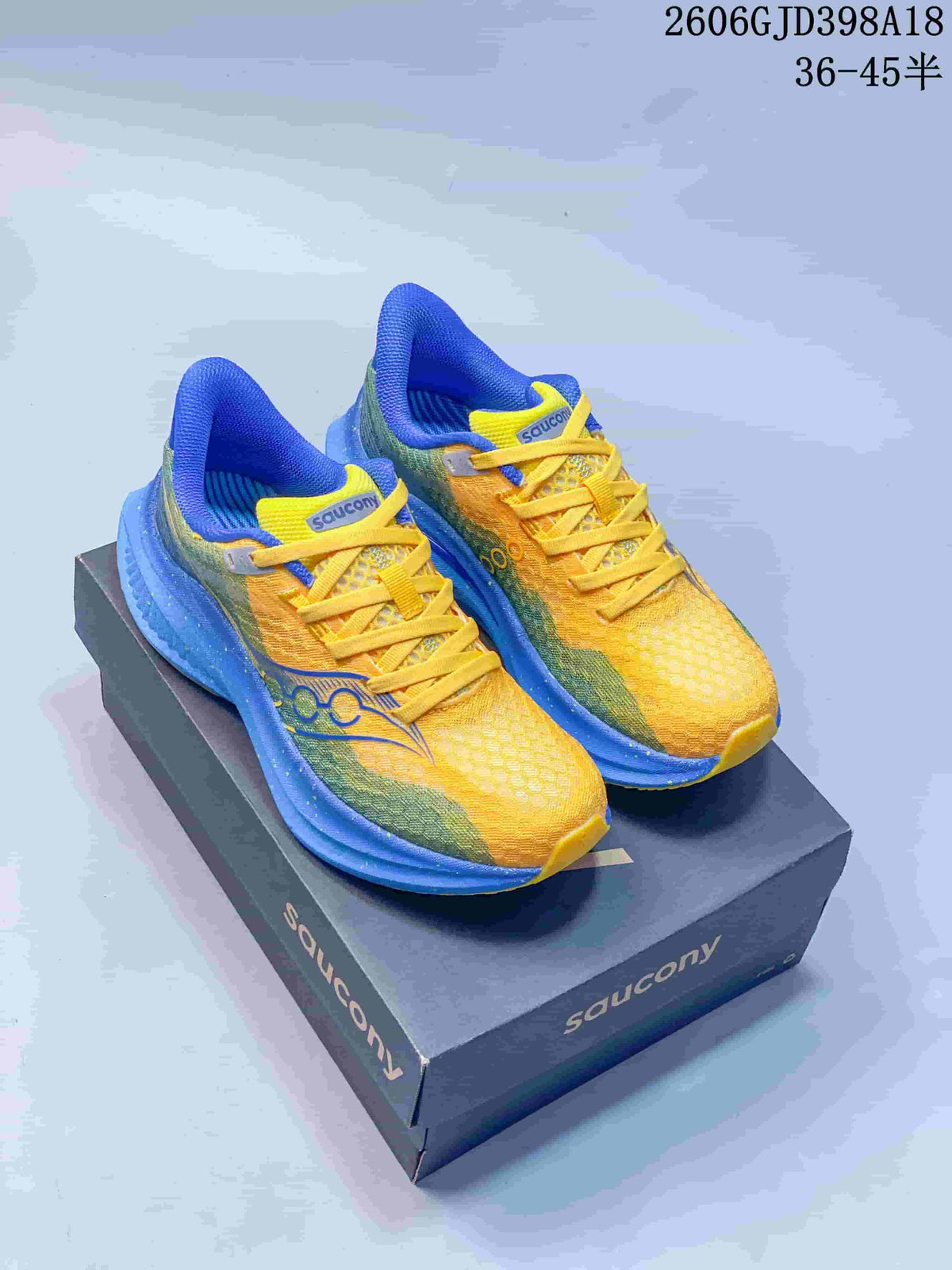 Pair of yellow, blue, and green Saucony Endorphin Speed 5 running shoes on a box