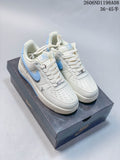 Pair of cream-white Nike Air Force 1 '07 low-top sneakers with light blue accents on a shoe box