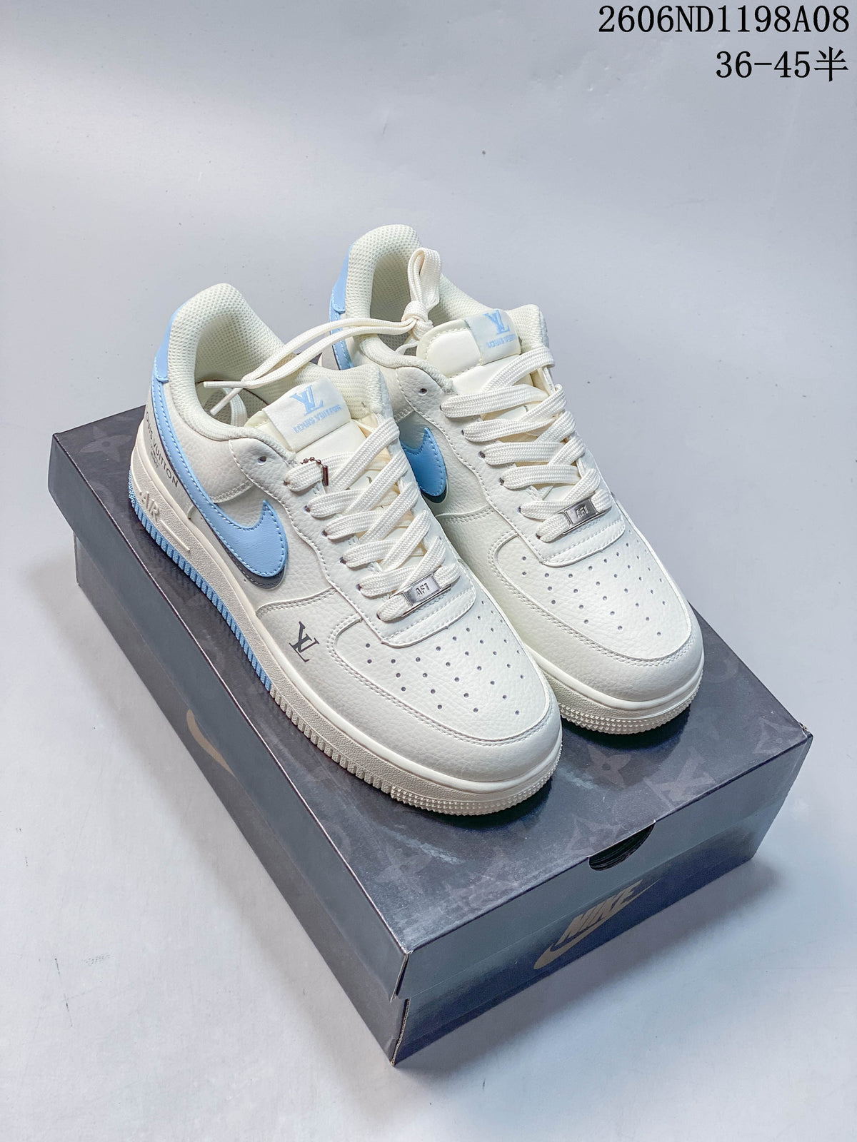 Pair of cream-white Nike Air Force 1 '07 low-top sneakers with light blue accents on a shoe box