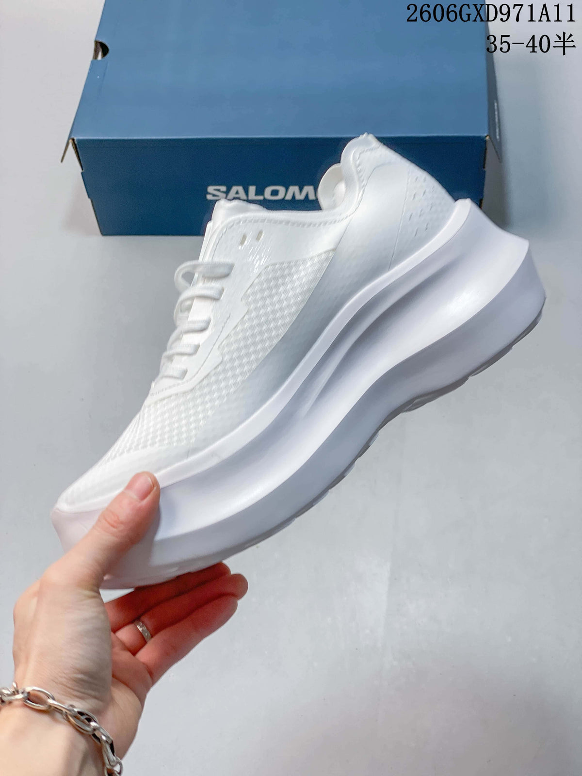 Side view of a white low-top sneaker with textured panels and a sculpted sole