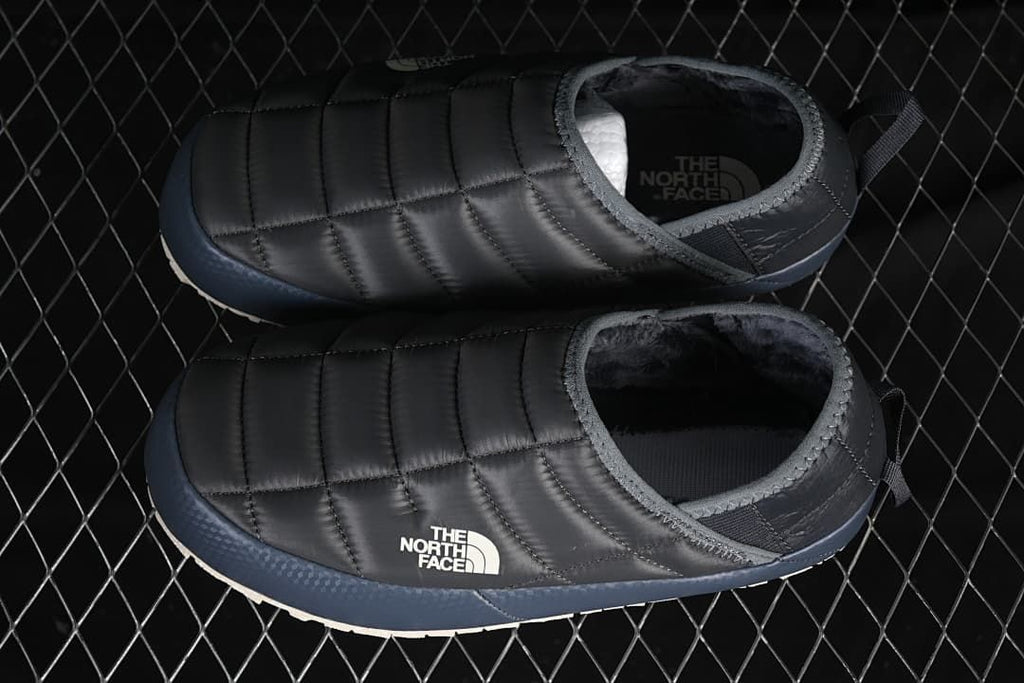 Pair of grey quilted mules shown from above and the side