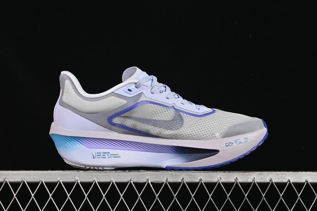 Outer side view of one shoe with gray, blue, and white details.