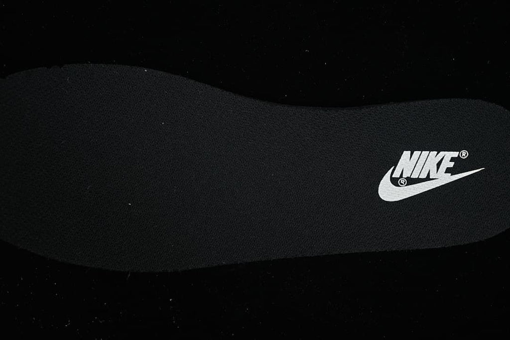 Close-up of a dark shoe insole with a visible Nike logo.