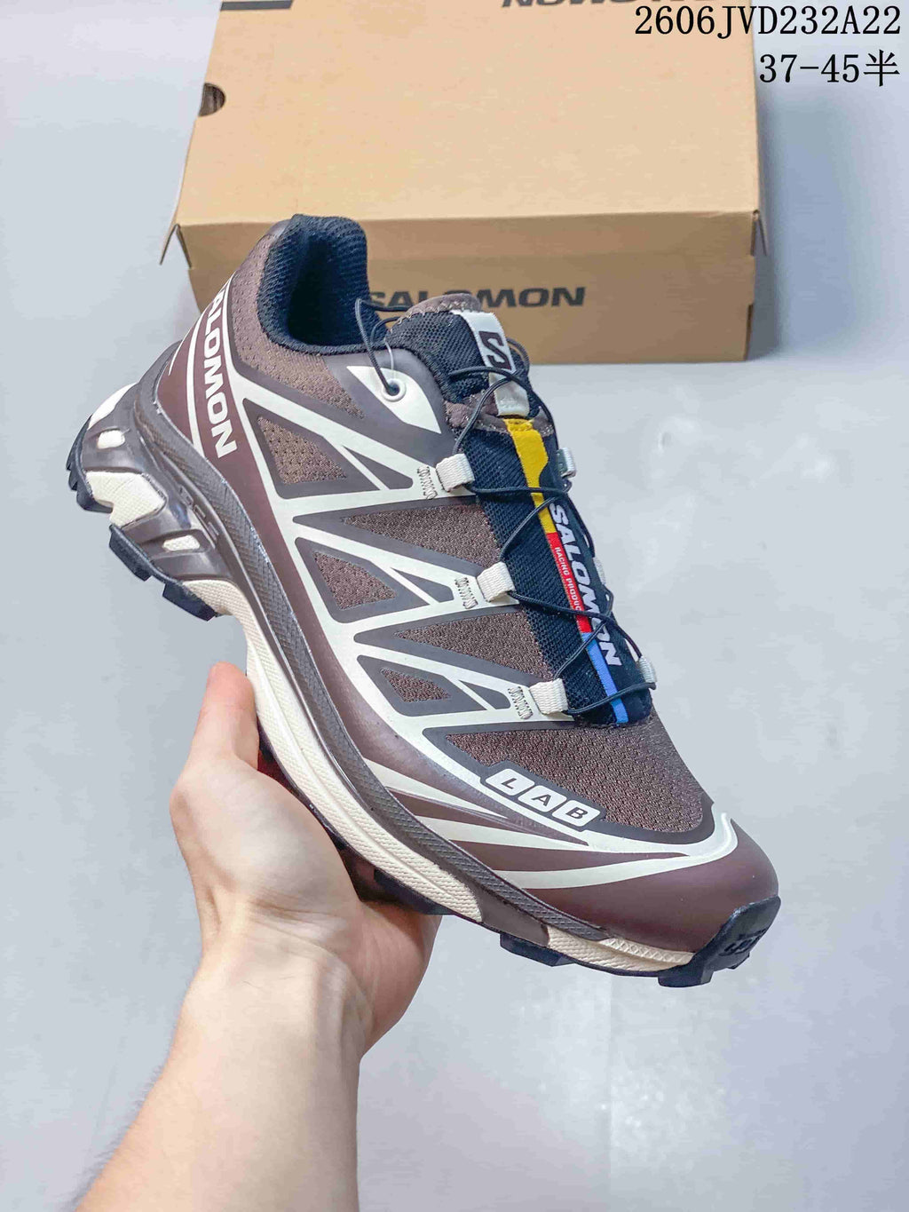 Angled side view of a brown and gray Salomon XT-6 trail shoe.