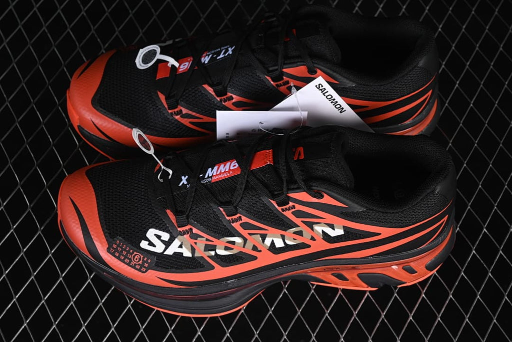Pair of black and tomato-red Salomon XT-MM6 sneakers