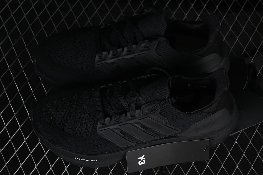 Pair of black Y-3 shoes displayed with a Y-3 hangtag.