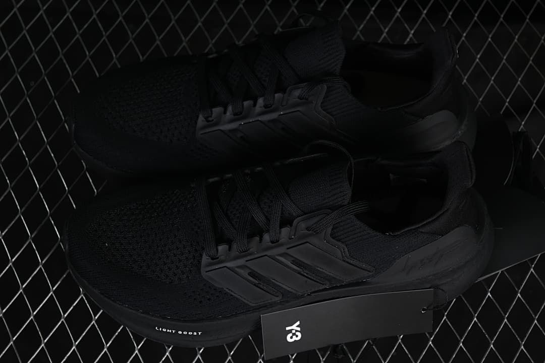 Pair of black Y-3 shoes displayed with a Y-3 hangtag.