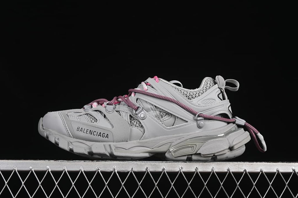 Grey Balenciaga Track sneaker with pink and grey cord laces, shown in profile