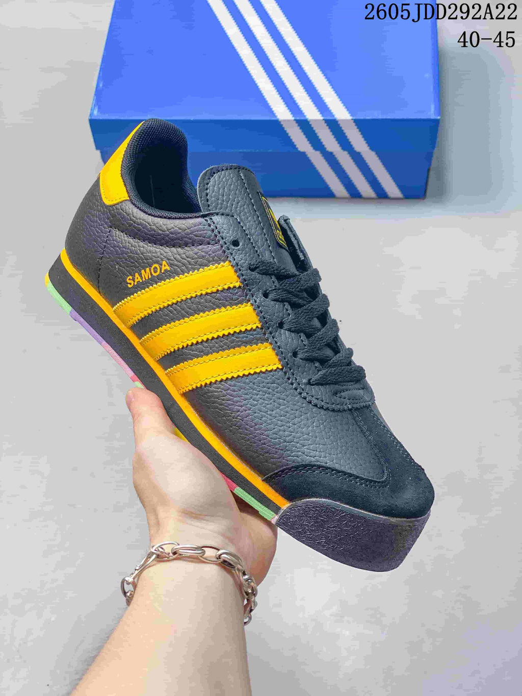 Dark gray Adidas Samoa low-top sneaker with yellow stripes