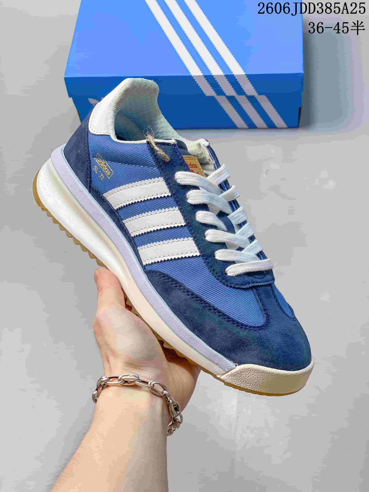 Angled side view of the blue sneaker with white stripes and navy overlays.