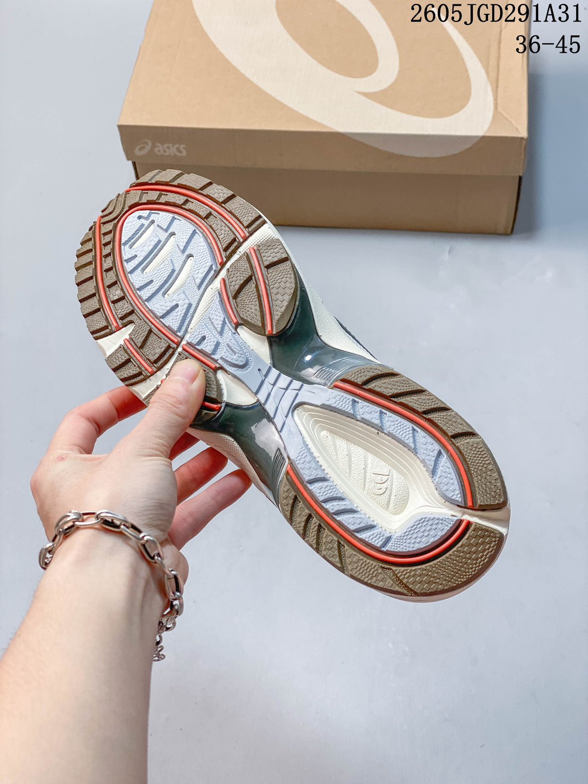 Close-up of the patterned outsole with gray, cream, and red details.
