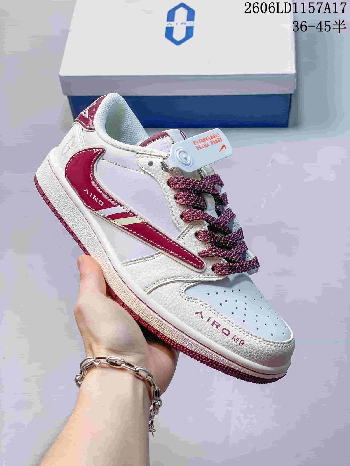 Angled view of the white and burgundy low-top sneaker