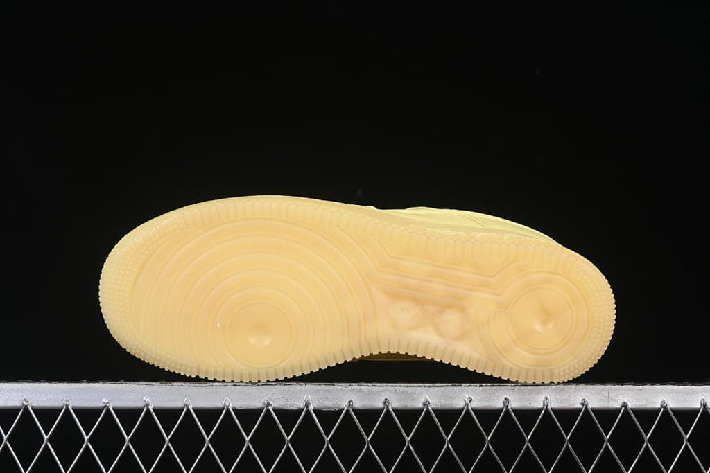 Underside view showing the pale yellow outsole tread
